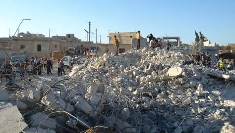 IDLIB, SYRIA - SEPTEMBER 23: Syrian children are on the ruins of a destroyed building as civil defense teams undertake a search and rescue operation among the ruins of it, in a region of Idlib, a northwestern city of Syria, on September 23, 2014. United States of America (USA) have launched air strikes against the targets of terrorist organization ISIL in Idlib, a northwestern city of Syria. (Photo by AA Video/Anadolu Agency/Getty Images)